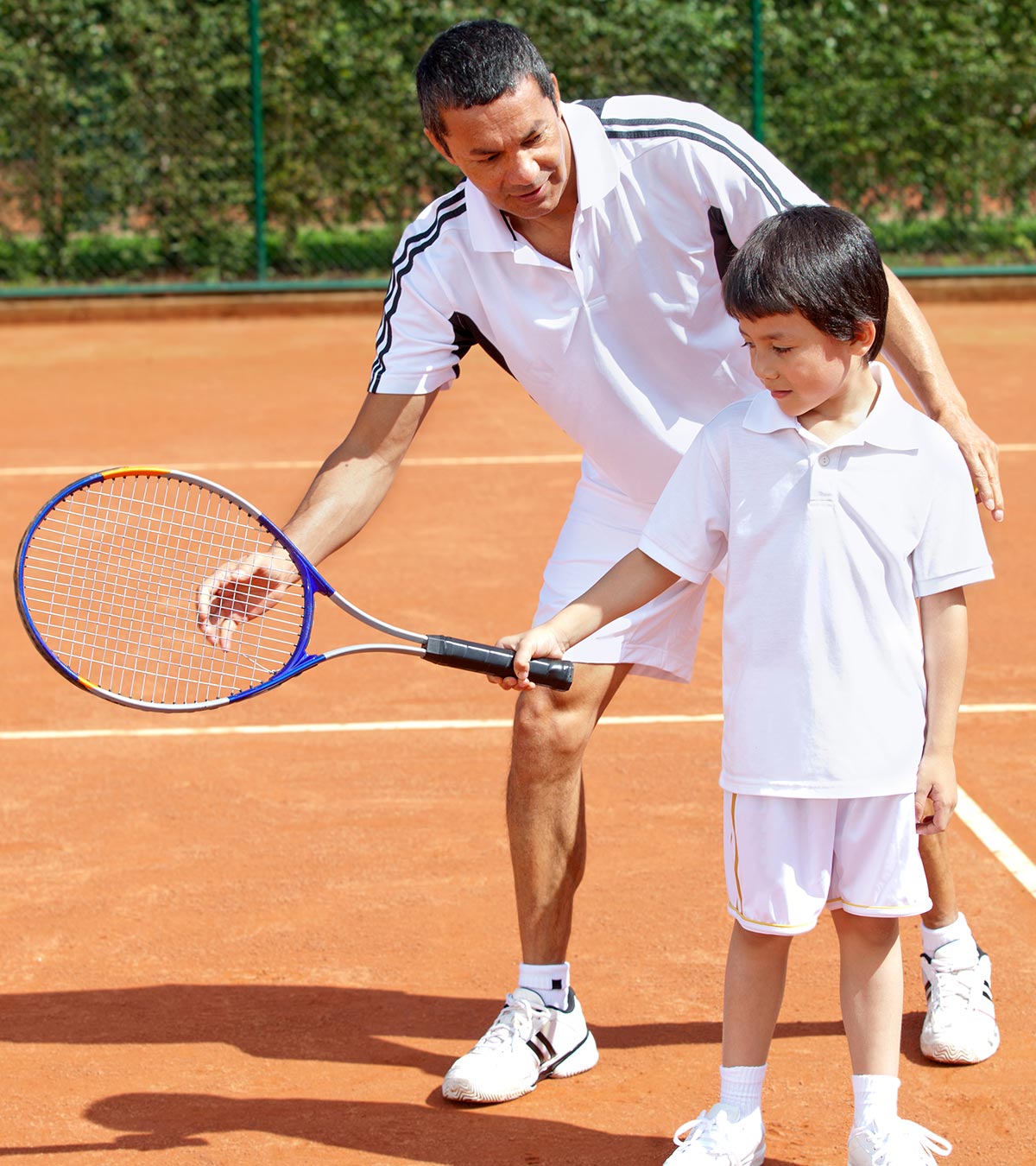 A kid playing tennis