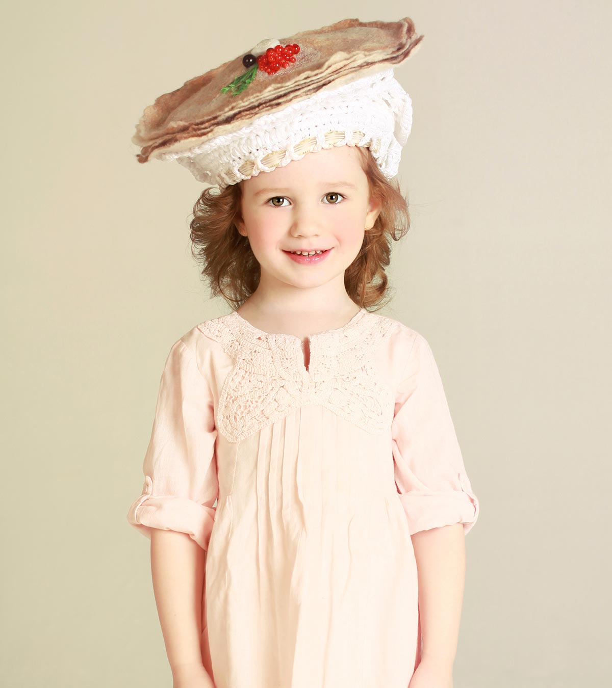 A small girl wears an easter hat