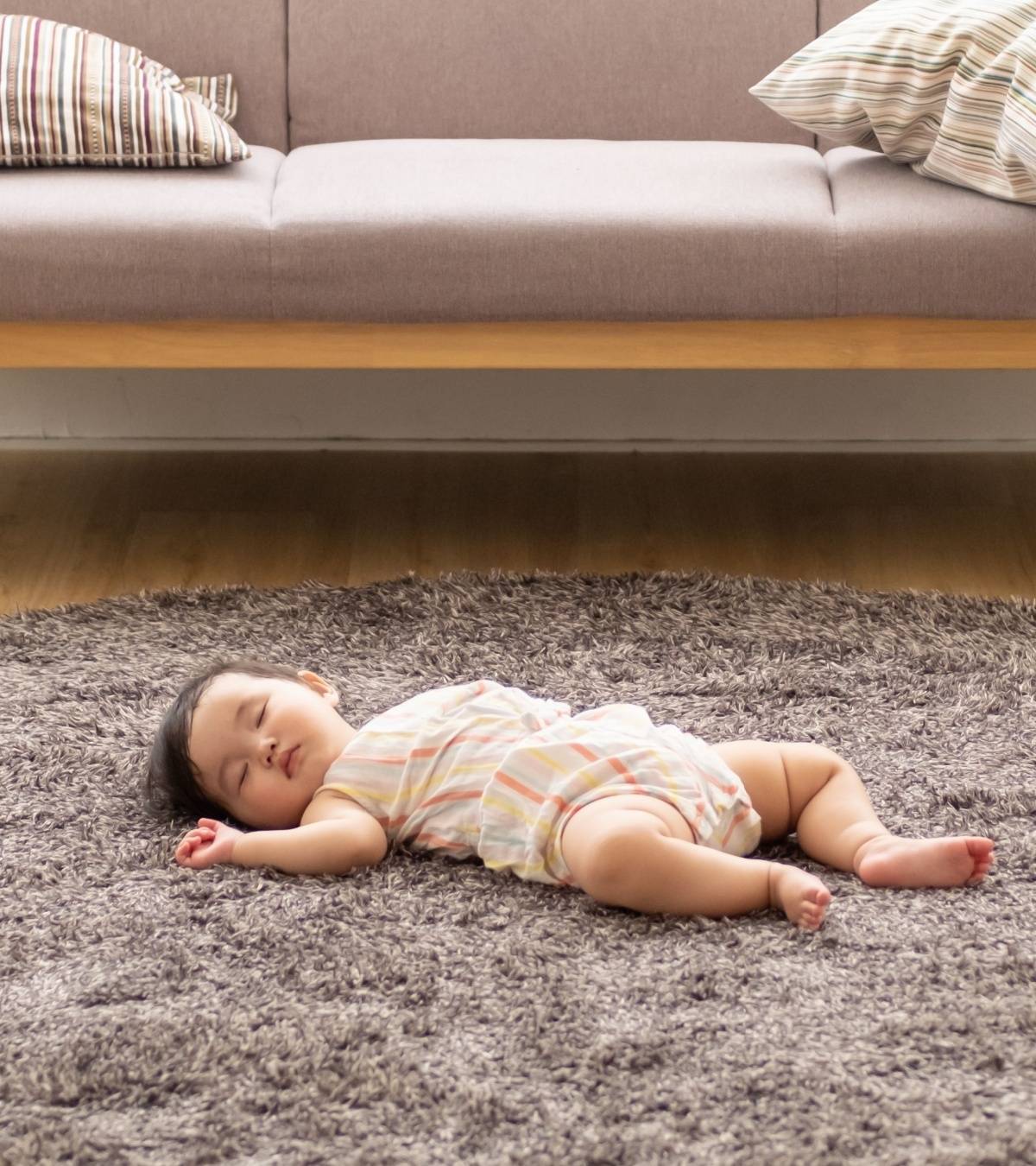 A Baby Sleeping On The Floor