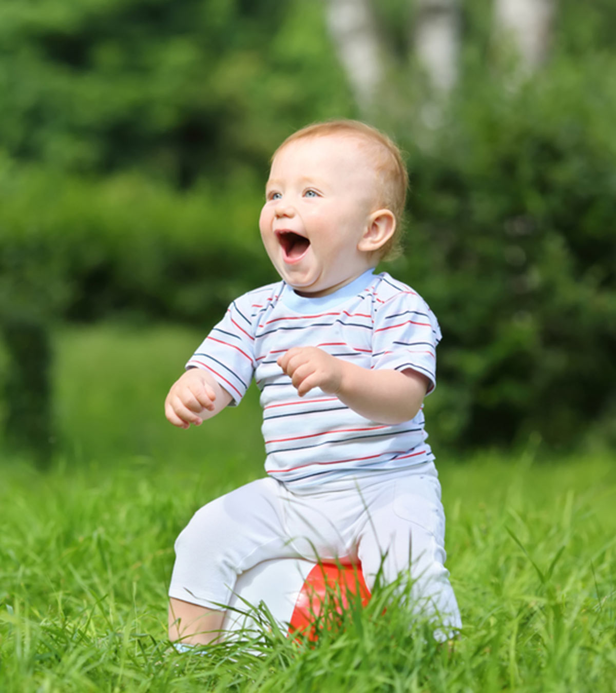 Baby Playing Outdoors With A Ball