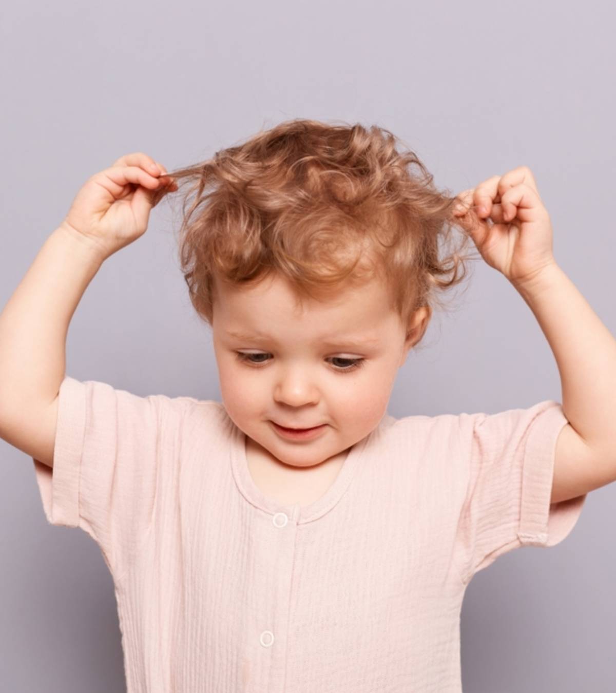 A Baby Pulling His Own Hair