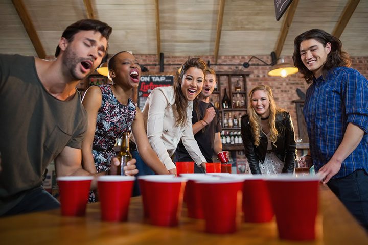 https://www.momjunction.com/wp-content/uploads/2022/10/Beer-pong-is-a-popular-drinking-game-adults-play-at-parties.jpg