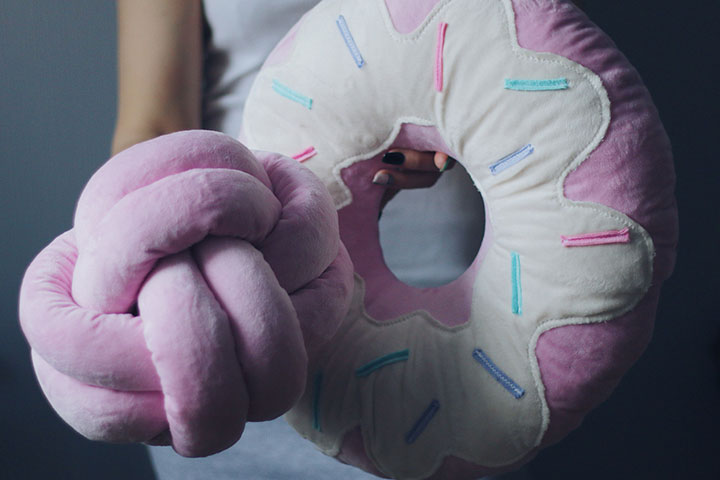 https://www.momjunction.com/wp-content/uploads/2022/10/Donut-cushions-may-help-get-relief-from-tailbone-pain.jpg