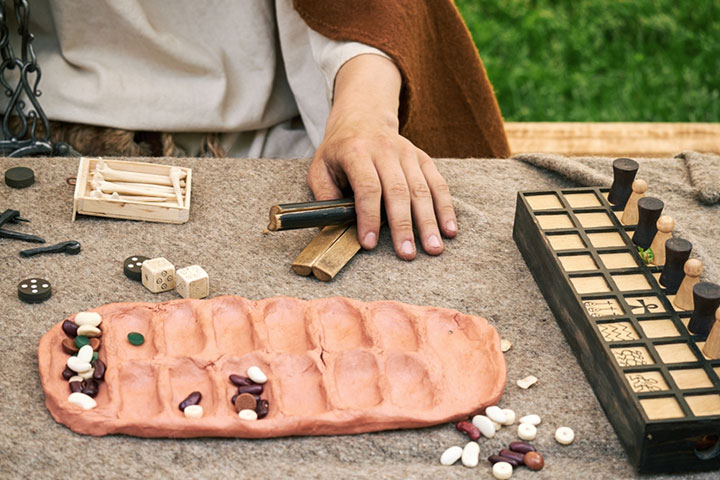 I am working on making my own Mancala game. I can make my own stones but  lack the tools/space/know-how to make the board itself. Would someone be  willing to make a board